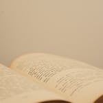 Open book with printed words, photographed in warm lighting with copyspace.